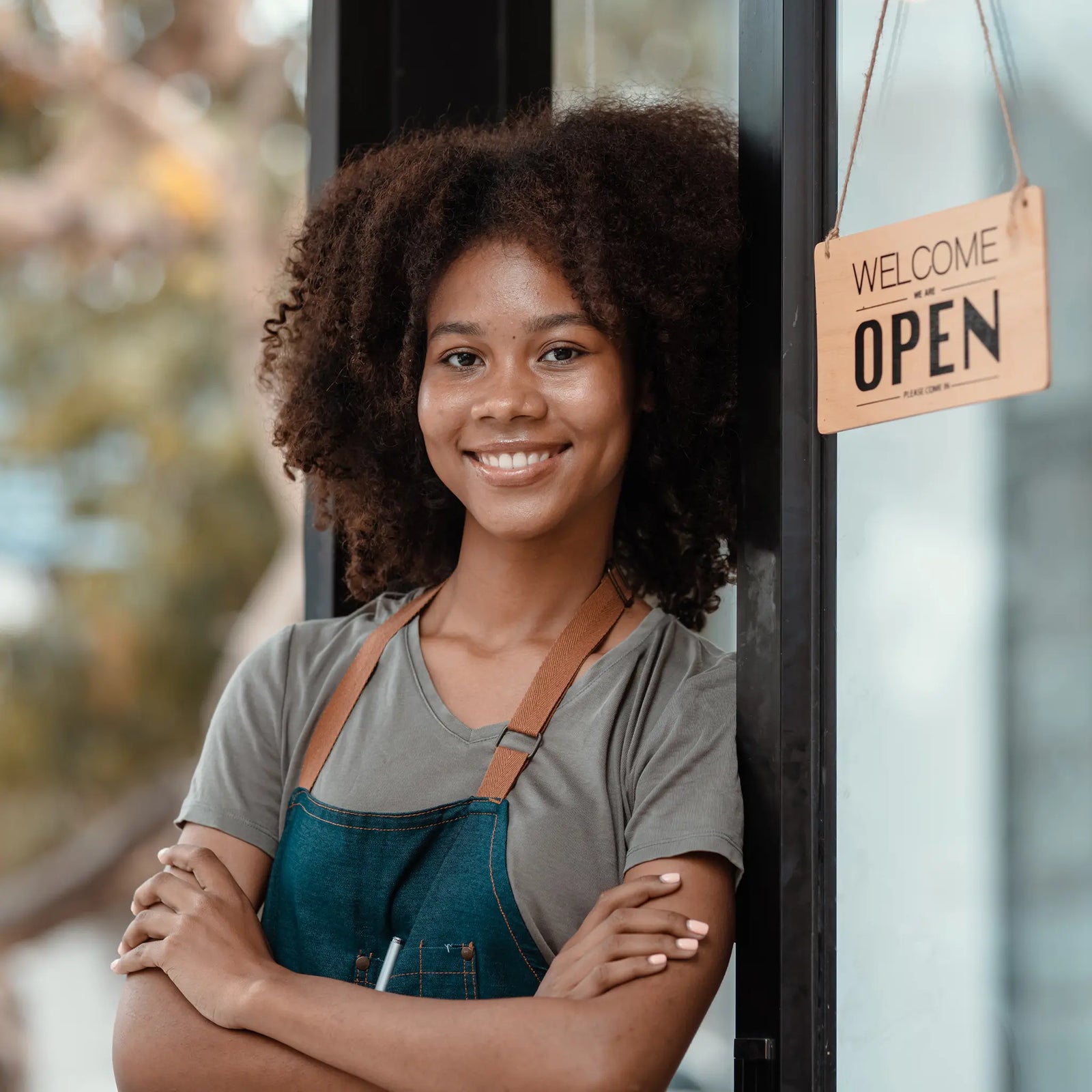 Woman shop owner opening up her store for the day